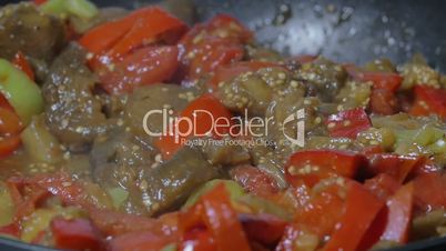 Pouring soy sauce into pan with vegetarian dish