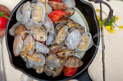 fresh clams on an iron skillet