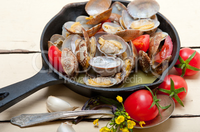 fresh clams on an iron skillet