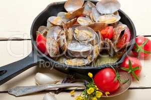 fresh clams on an iron skillet