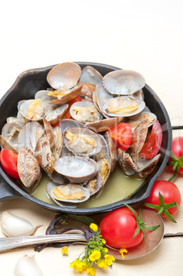 fresh clams on an iron skillet