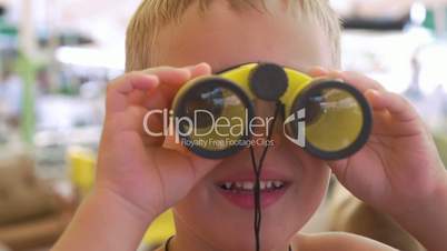 Child looking through the binoculars