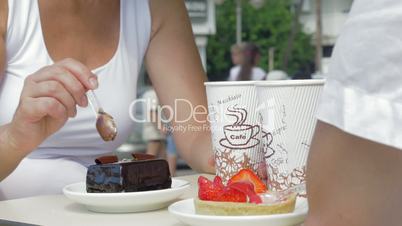 People eating desserts and drinking coffee in cafe