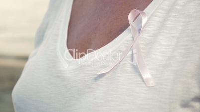 Senior woman wearing pink awareness ribbon