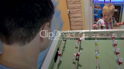 Father and Son Playing Foosball in Arcade