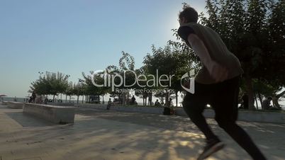 Free runner on city square on sunny day