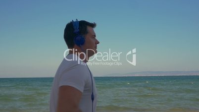 Man jogging with music at the seaside