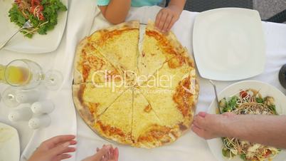 Family taking delicious cheese pizza