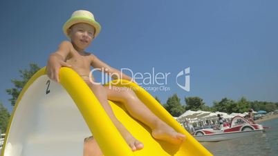 Child riding on slider at seaside