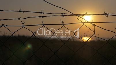 Sunset behind the barbed wire