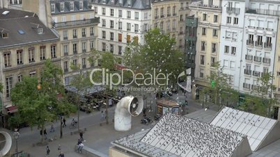 Flock of pigeons flying on the city square in Paris