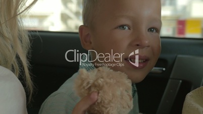 Boy with Plush Toy on the Car Back Seat