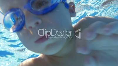 Underwater swimming of a child in goggles