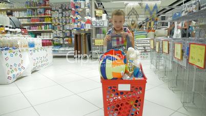 Child going shopping in the supermarket