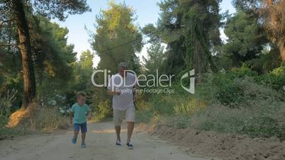 Grandfather and grandson jogging in the forest