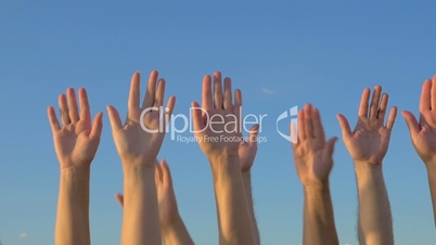 Hands up on blue sky background