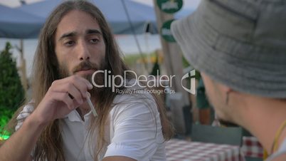 Two friends talking in outdoor cafe