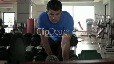 Man exercising with dumbbell in the gym