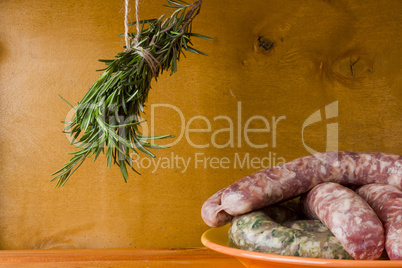 Raw pork sausages and a bunch of rosemary
