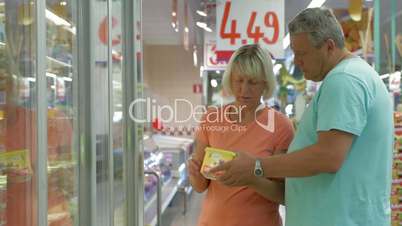 Senior couple choosing products in the store