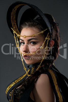 Portrait of pretty dancer in headdress with beads