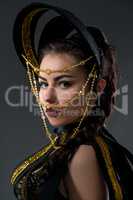 Portrait of pretty dancer in headdress with beads