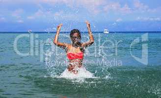Girl splashing seawater