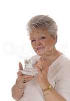 Senior woman holding coffee cup.
