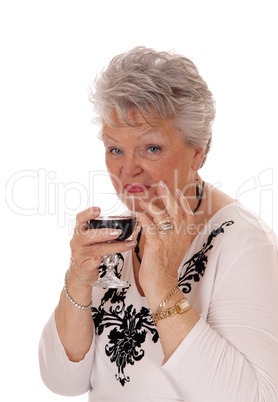 Senior woman holding a glass of wine.