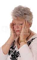 Senior woman holding her head for headache.