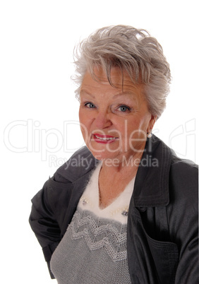 Closeup of senior woman standing in a coat.