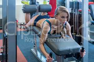 In gym. Sexy girl during training on simulator