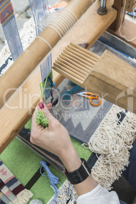 Young woman weaving loom