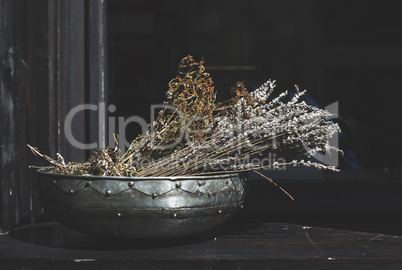 Herbs cumin and cilantro in a metal bowl