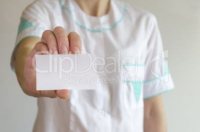 Doctor's hand holding blank business card