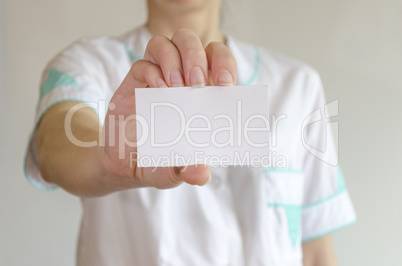 Doctor's hand holding blank business card