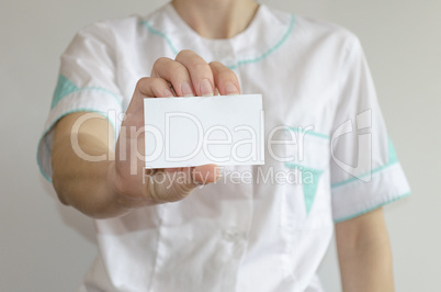 Doctor's hand holding blank business card