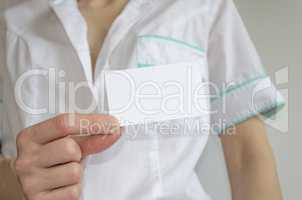 Doctor's hand holding blank business card