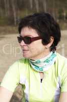 Woman sitting on the beach and takes a rest