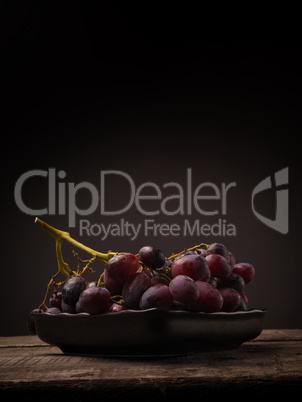 Red grapes on a wooden table