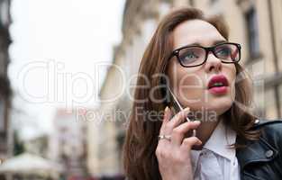pretty woman in the city speaking using smartphone