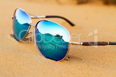 Sunglasses on the sand in the desert.