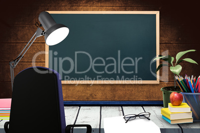 Composite image of a desk with lamp and documents