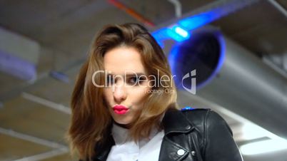 Sexy woman wearing leather jacket and shirt in the car park garage