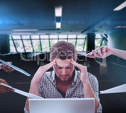 Composite image of businessman stressed out at work