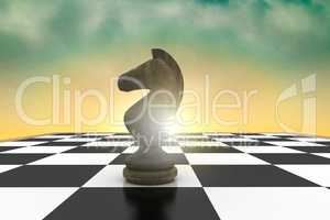 Composite image of black knight on chess board