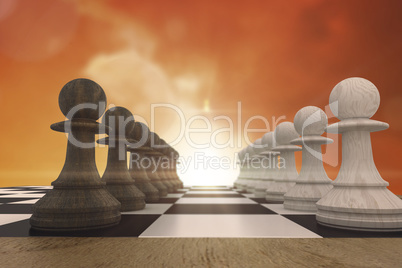 Composite image of black and white pawns facing off