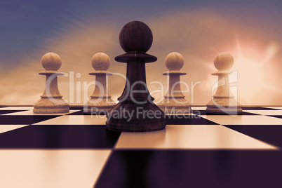 Composite image of black pawn in front of white pawns