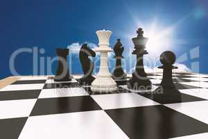Composite image of white queen standing with black chess pieces