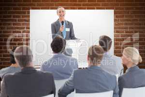 Composite image of businesswoman doing speech during meeting